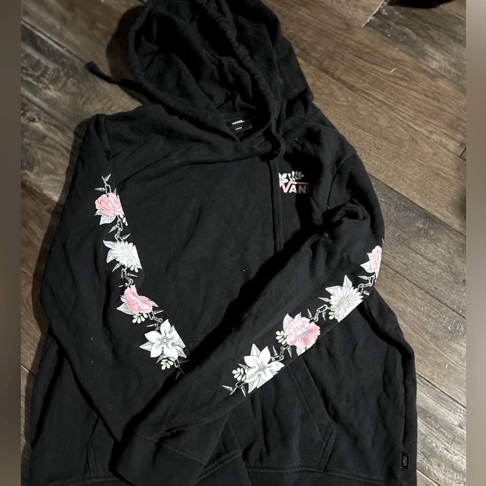I am selling a women’s hoodie from Vans. It is black with flowers on it